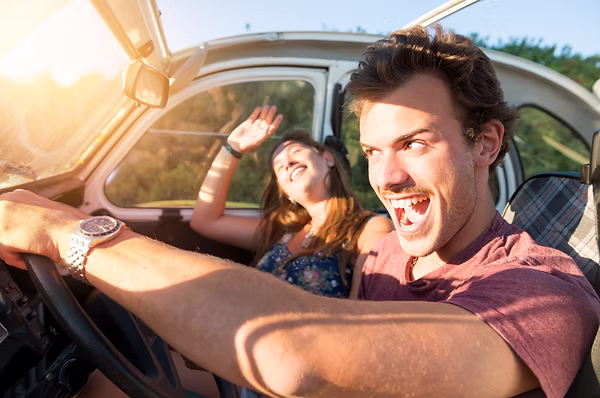 A young man recklessly driving car with his girlfriend